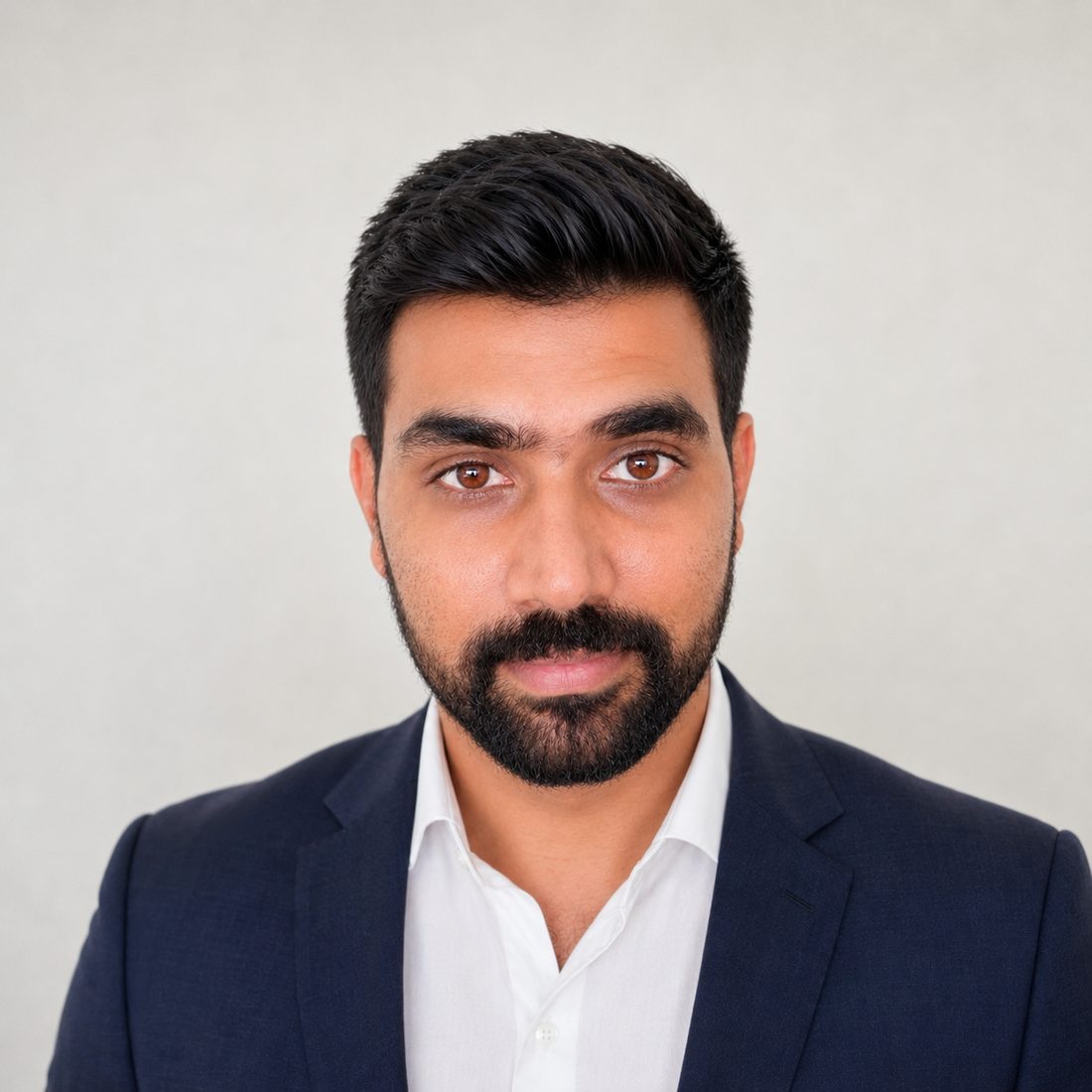 Balmiki Prasad in a navy suit